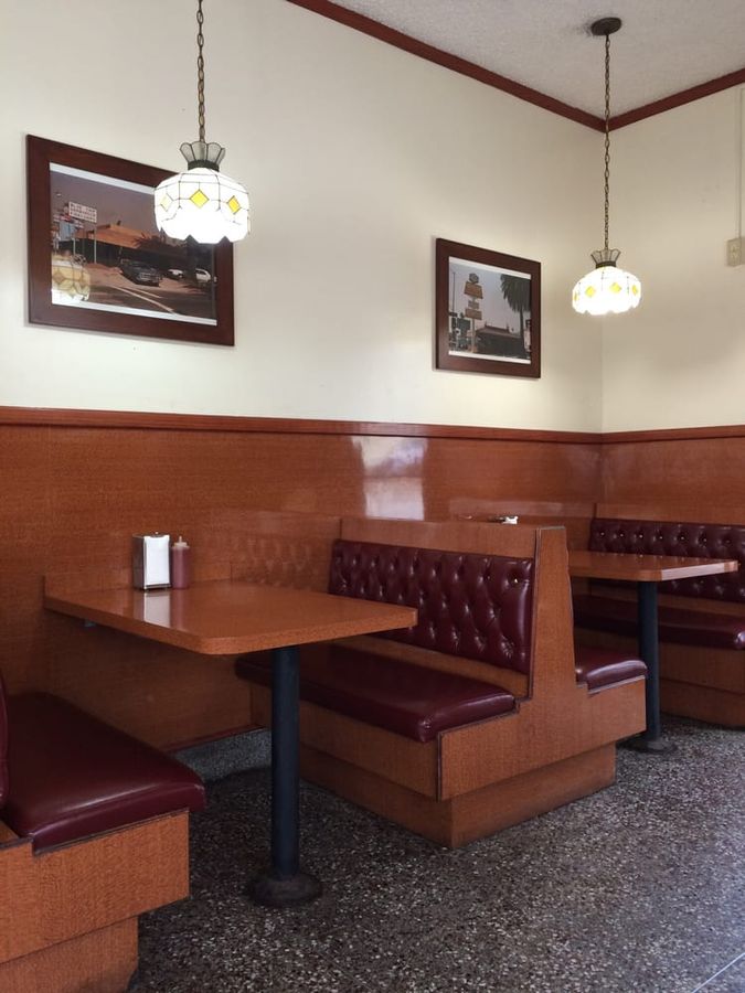 Inside Pete's Blue Chip: oxblood tufted leather booths, wood paneling and stained-glass pendant lamps
