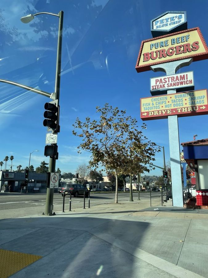 Pete's Blue Chip roadside sign towering over the corner of Colorado Boulevard on a sunny day
